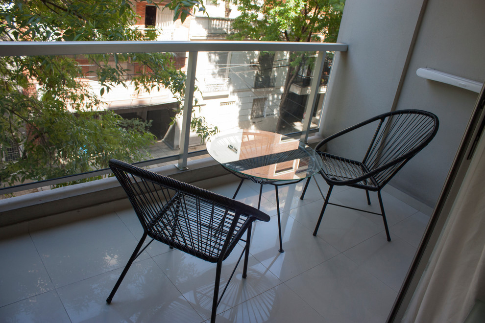 Small minimalist glass railing balcony photo in Other
