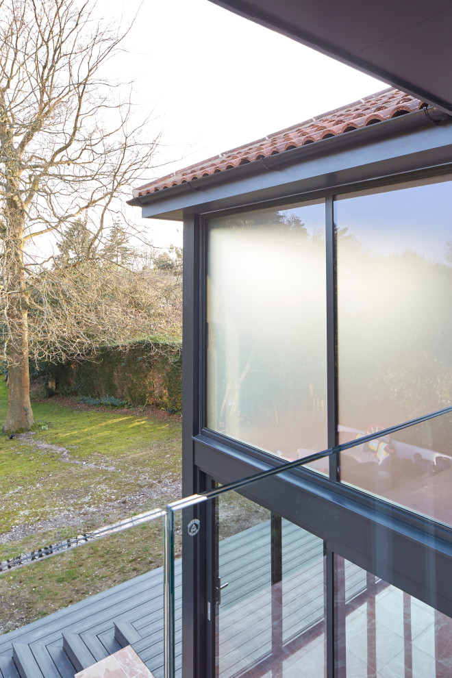 Balcony - contemporary glass railing balcony idea in Berkshire with no cover