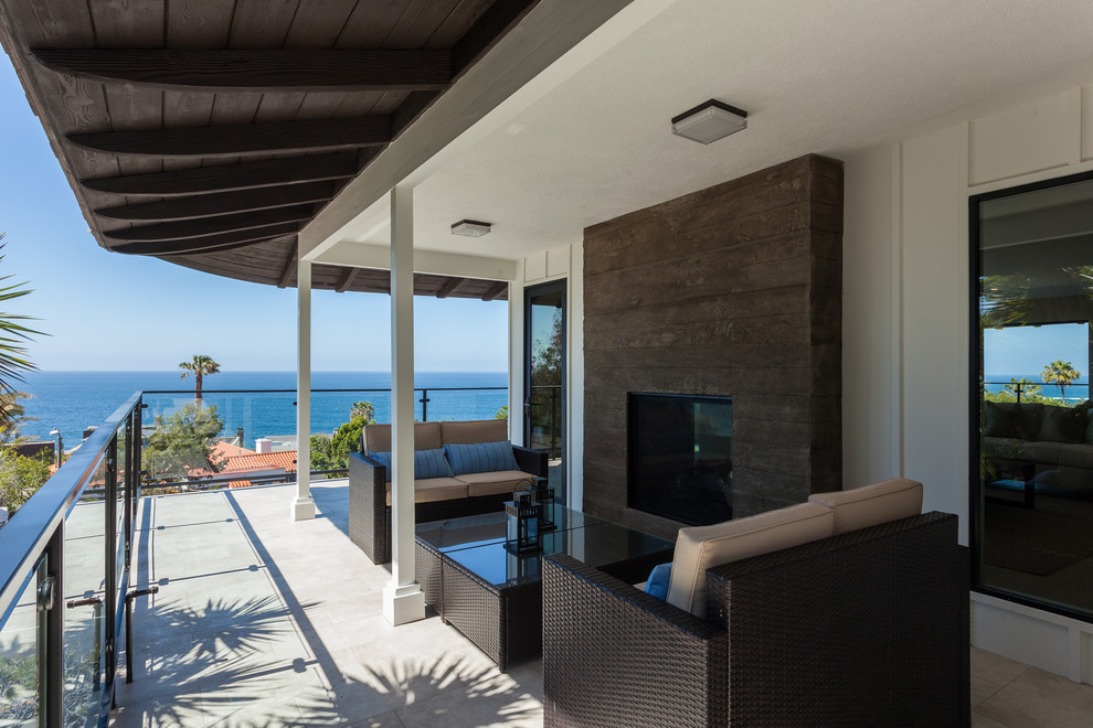 Photo of a large contemporary balcony in Orange County with a roof extension.