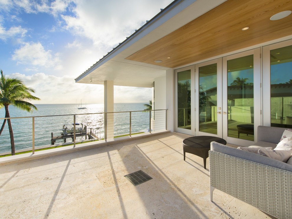 Expansive modern balcony in Miami with a roof extension.