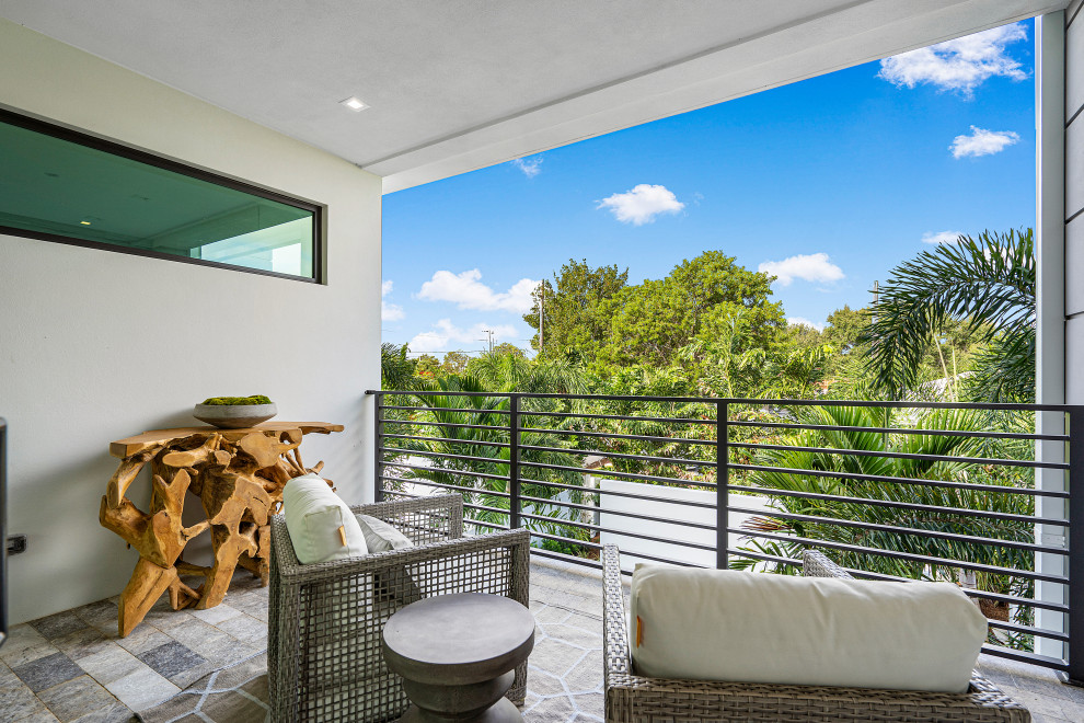 Mid-sized trendy metal railing balcony photo in Miami with a roof extension