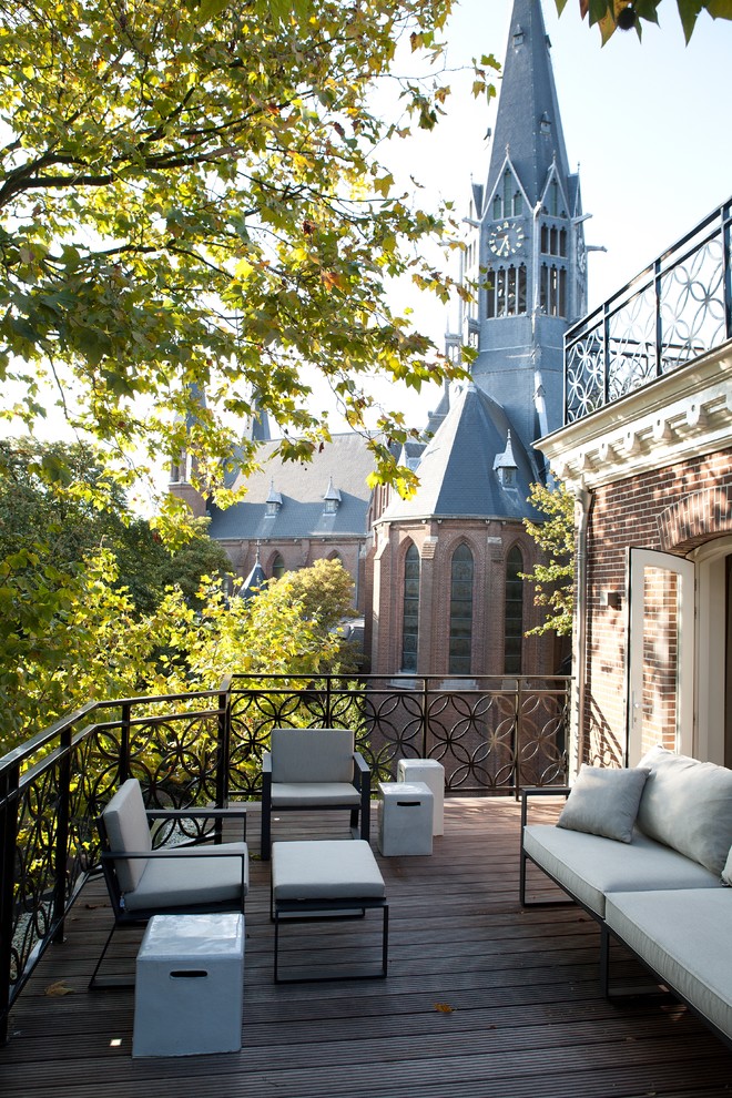 This is an example of a large traditional balcony in Amsterdam with no cover.