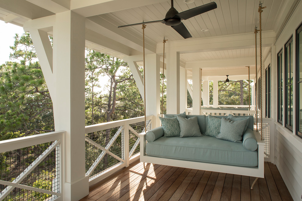 Design ideas for a nautical wood railing balcony in Miami with a roof extension.