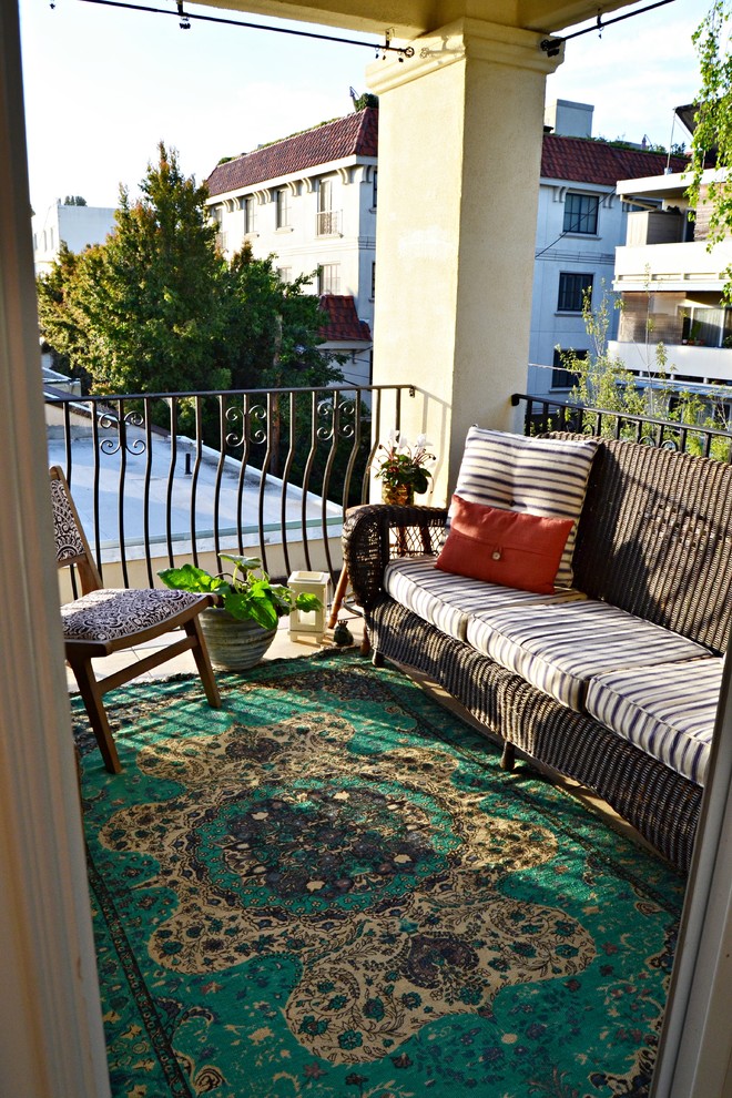 Design ideas for a small rustic balcony in Atlanta with a roof extension.