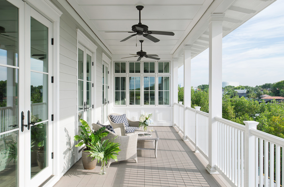Inspiration for a large traditional balcony in Tampa with a roof extension.