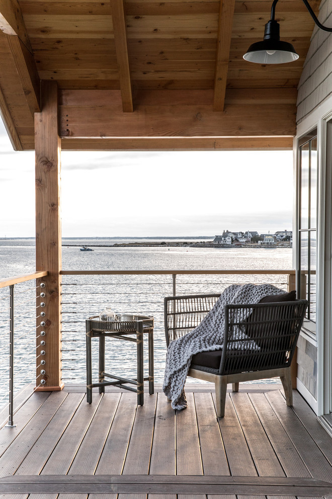 Small beach style balcony photo in Portland Maine with a roof extension