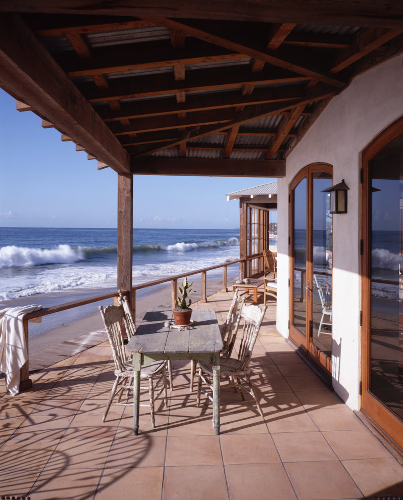 This is an example of a beach style balcony in Los Angeles with a roof extension.