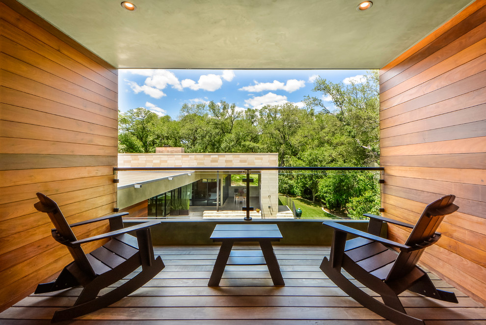 Design ideas for a contemporary balcony in Austin with a roof extension.