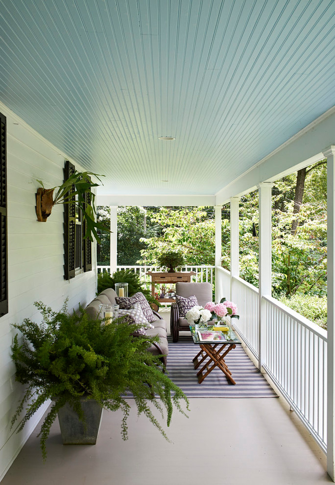 This is an example of a farmhouse balcony in New York with a roof extension.