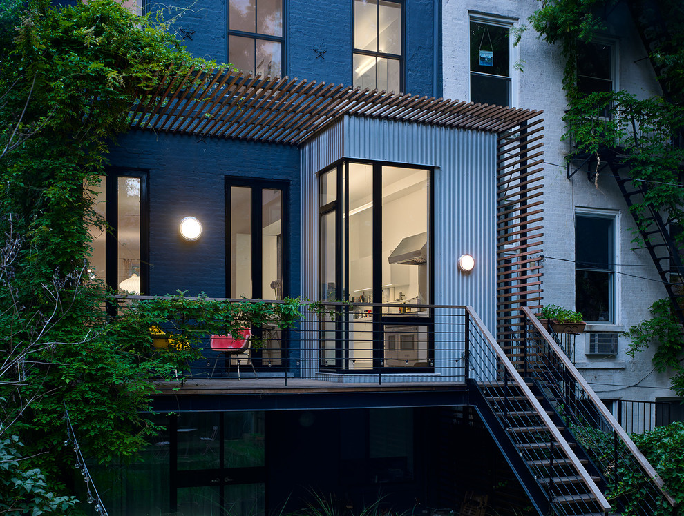 Photo of a medium sized contemporary mixed railing balcony in New York with a pergola.