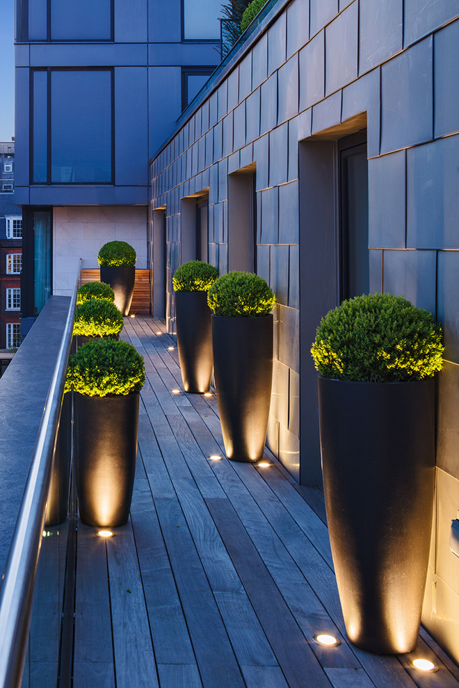 This is an example of a contemporary balcony in London with feature lighting.