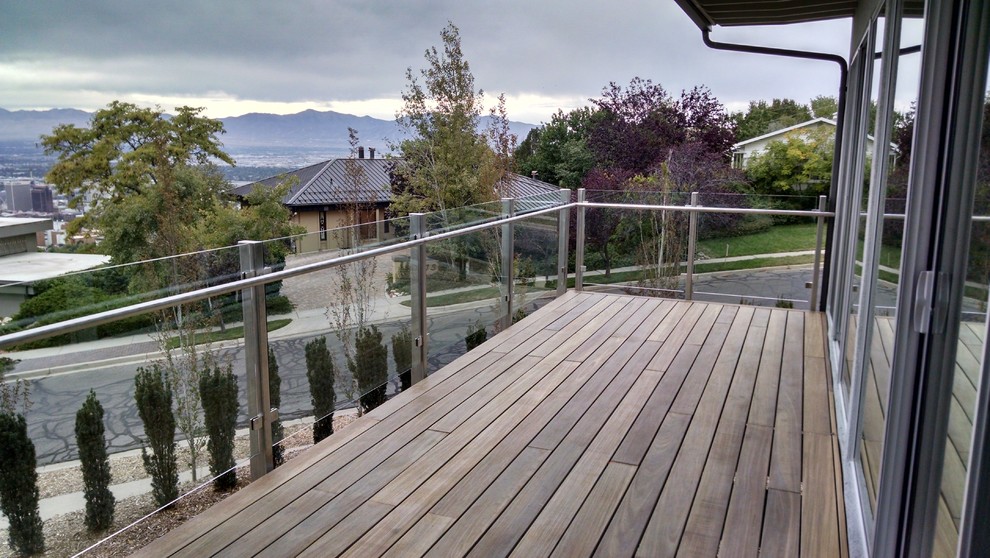 This is an example of a large modern glass railing balcony in Salt Lake City with no cover.
