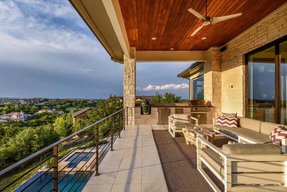 Large trendy metal railing balcony photo in Austin with a roof extension