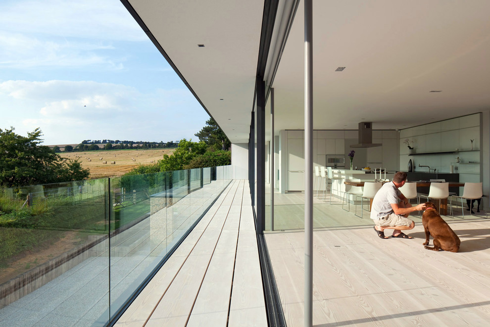 Inspiration for a contemporary balcony in Hampshire with a roof extension.