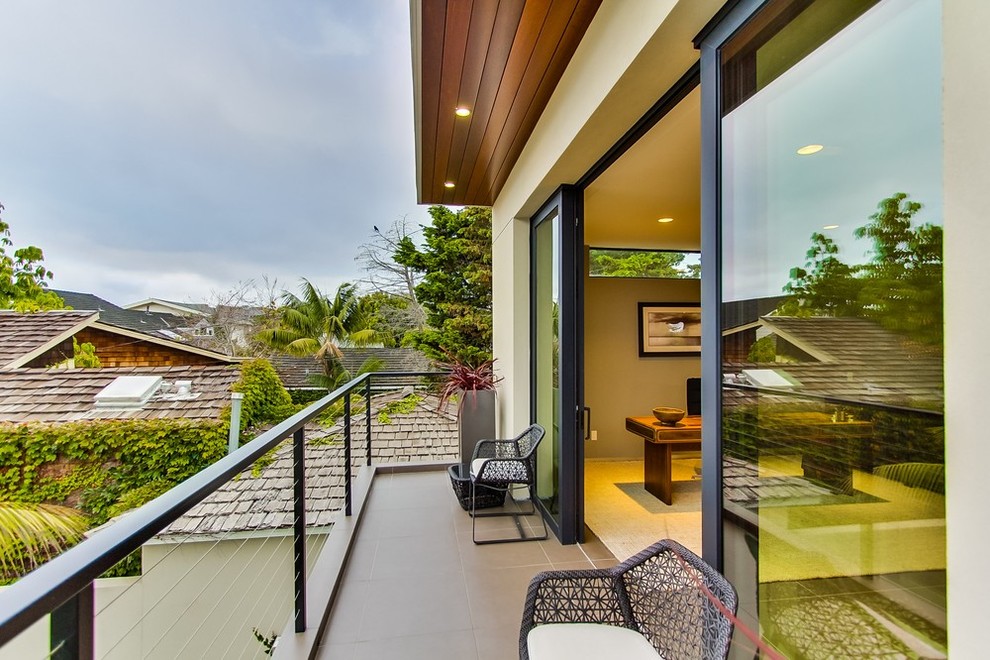 Inspiration for a small contemporary balcony remodel in San Diego with a roof extension