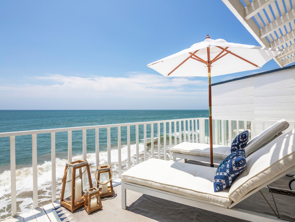 This is an example of a beach style balcony in Los Angeles with an awning.