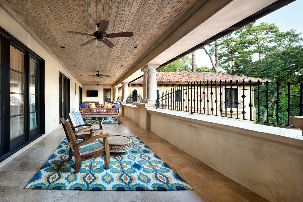 Large tuscan balcony photo in Austin with a roof extension