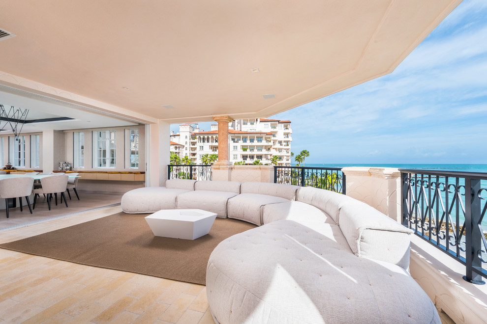 Inspiration for an expansive contemporary balcony in Miami with a roof extension.