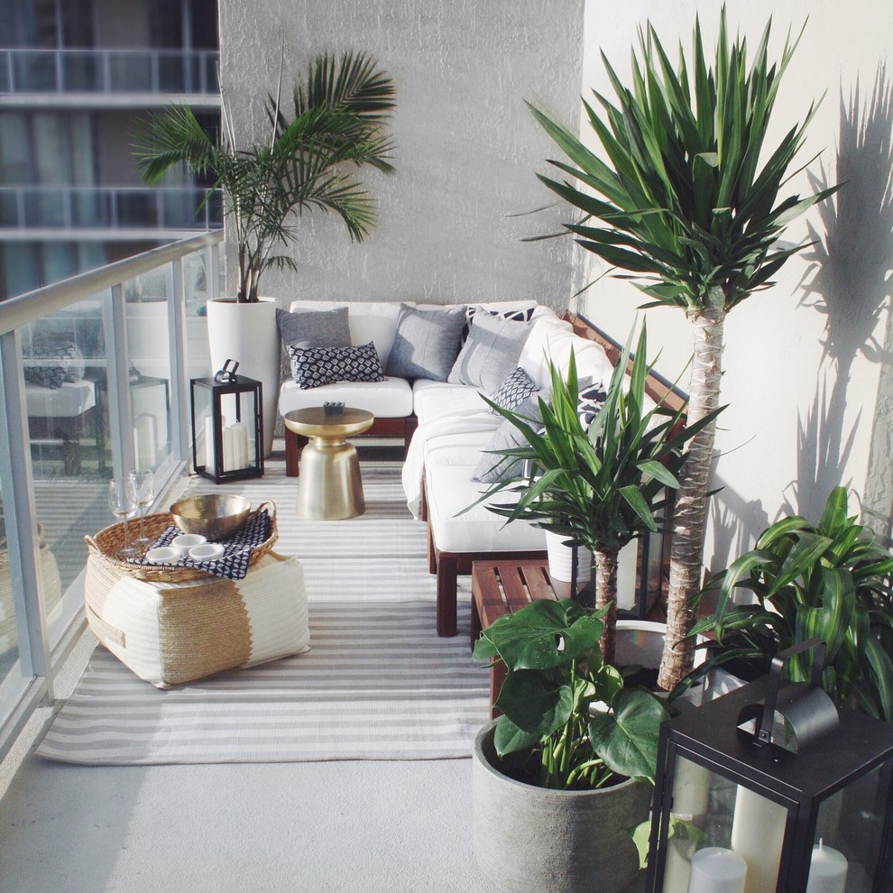 Inspiration for a small balcony remodel in Miami with a roof extension