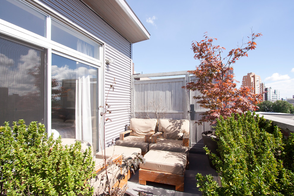 Inspiration for an industrial privacy balcony remodel in New York with no cover