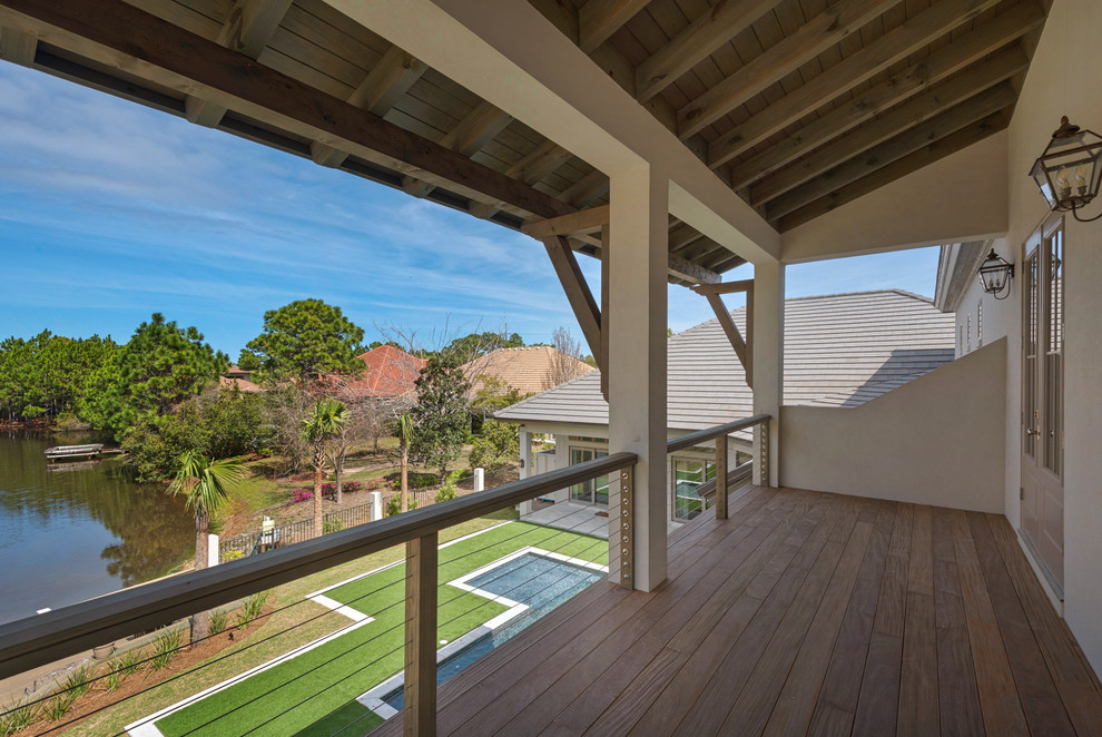 Large beach style balcony photo in Other with a roof extension
