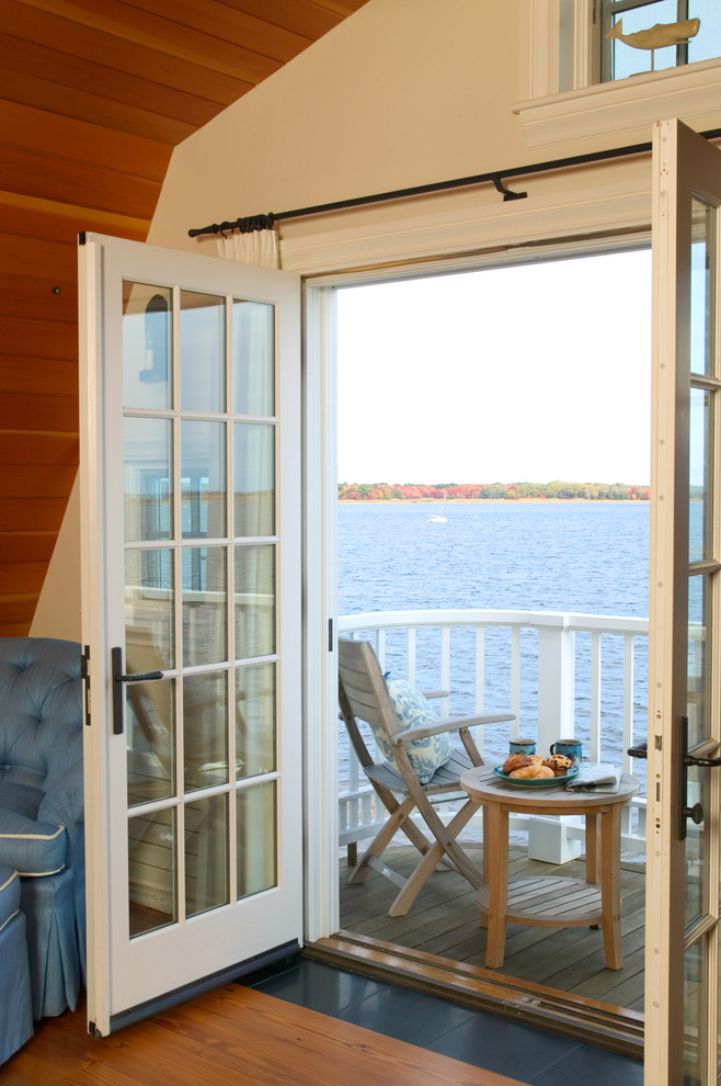 Photo of a small beach style balcony in Boston with a roof extension.