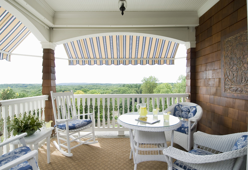 Example of a classic balcony design in Bridgeport with a roof extension