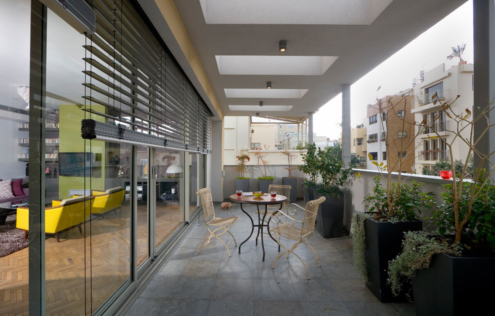 Inspiration for a contemporary balcony remodel in Other with a roof extension