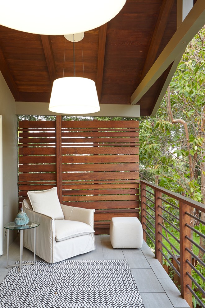 Example of a transitional privacy balcony design in San Francisco with a roof extension