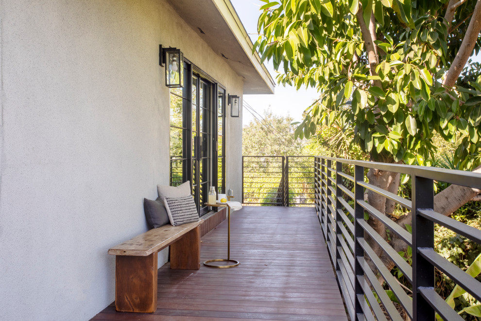 Large midcentury metal railing balcony in Los Angeles with no cover.