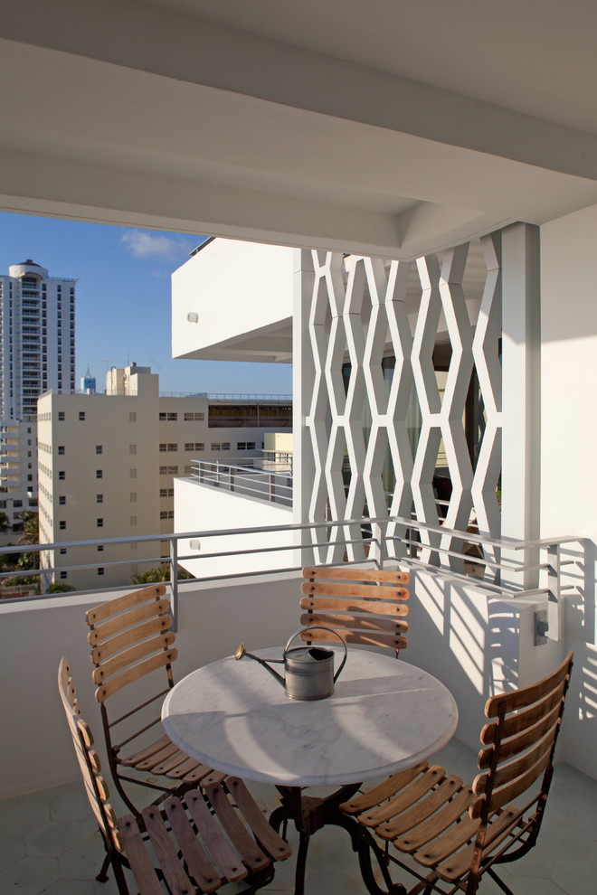 Design ideas for a contemporary apartment balcony in Miami with a roof extension.