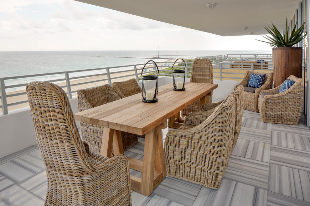 Balcony - mid-sized coastal balcony idea in Miami with a roof extension
