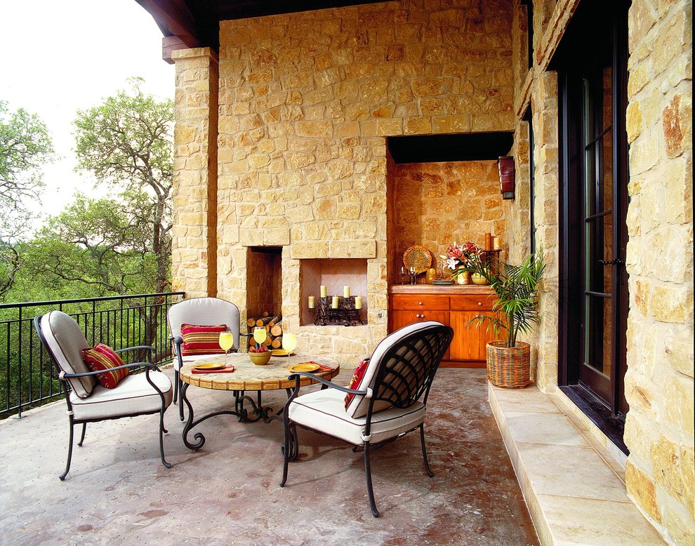 Photo of a mediterranean balcony in Austin with a roof extension.