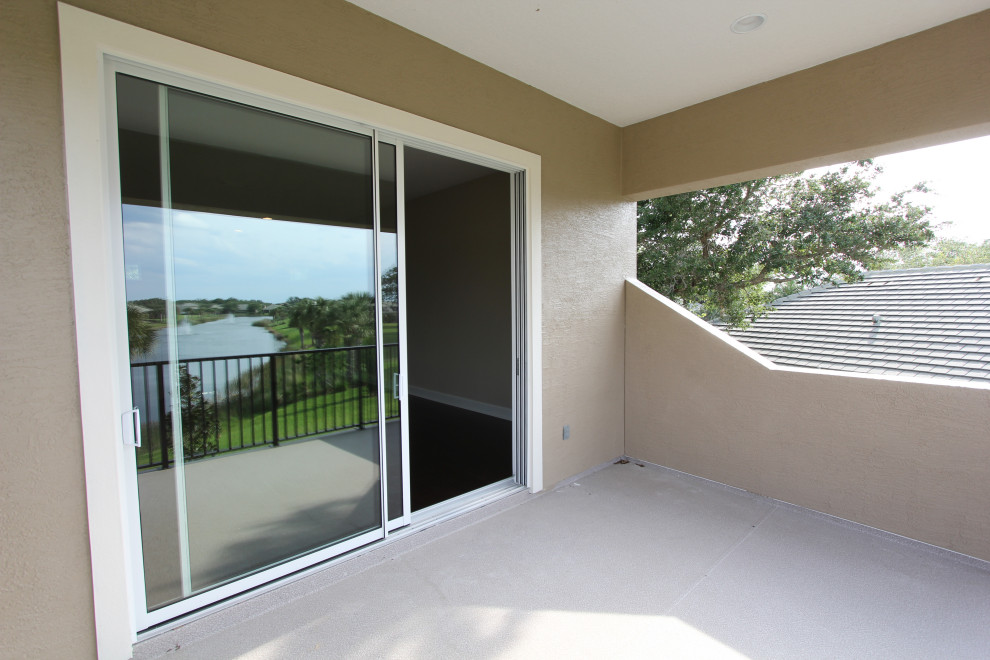 Large classic metal railing balcony in Orlando with a roof extension.