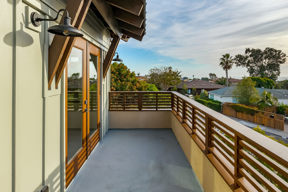 Mid-sized transitional mixed material railing balcony photo in San Diego with a roof extension
