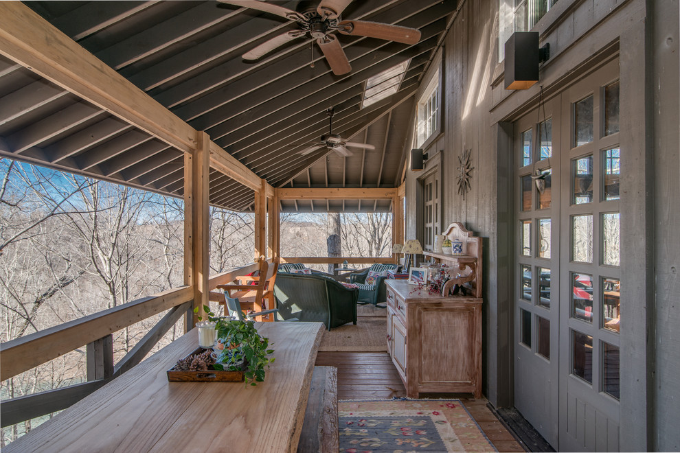 Inspiration for a mid-sized rustic balcony remodel in Nashville with a roof extension