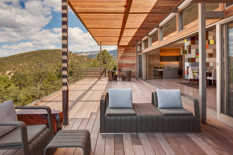 Inspiration for a large contemporary balcony in Albuquerque with a roof extension.