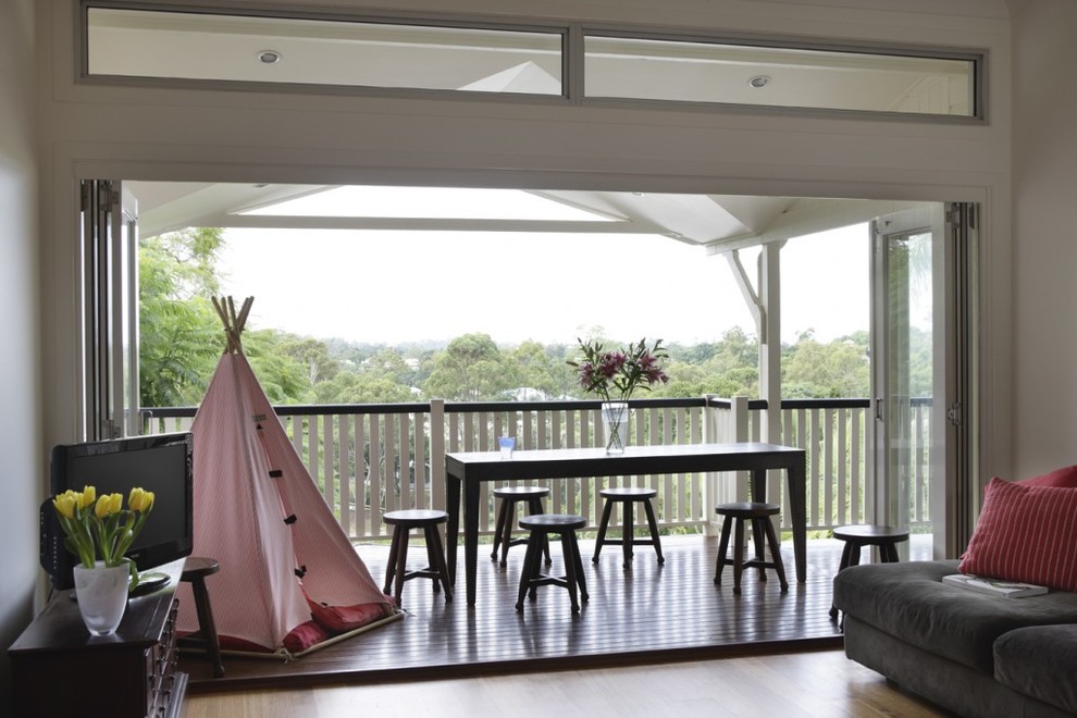 Inspiration for a large contemporary wood railing balcony in Brisbane with a roof extension.