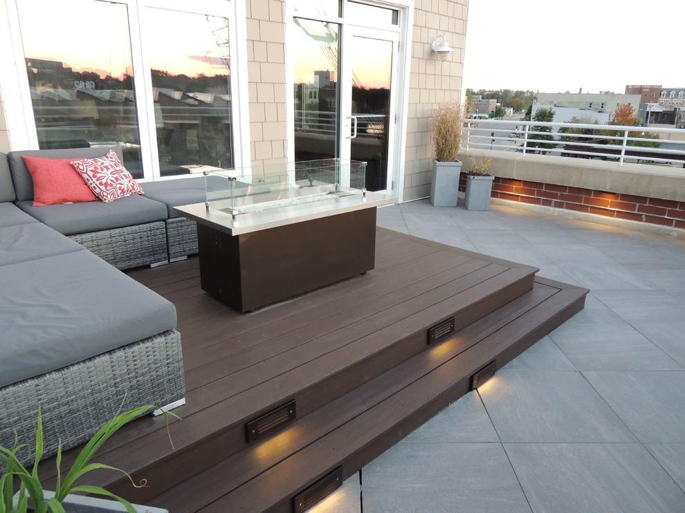 Inspiration for a small modern metal railing balcony remodel in Other with a fire pit
