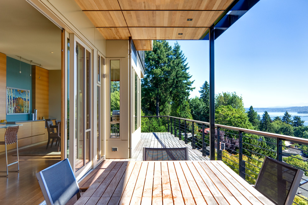 This is an example of a large contemporary balcony in Seattle with an awning.
