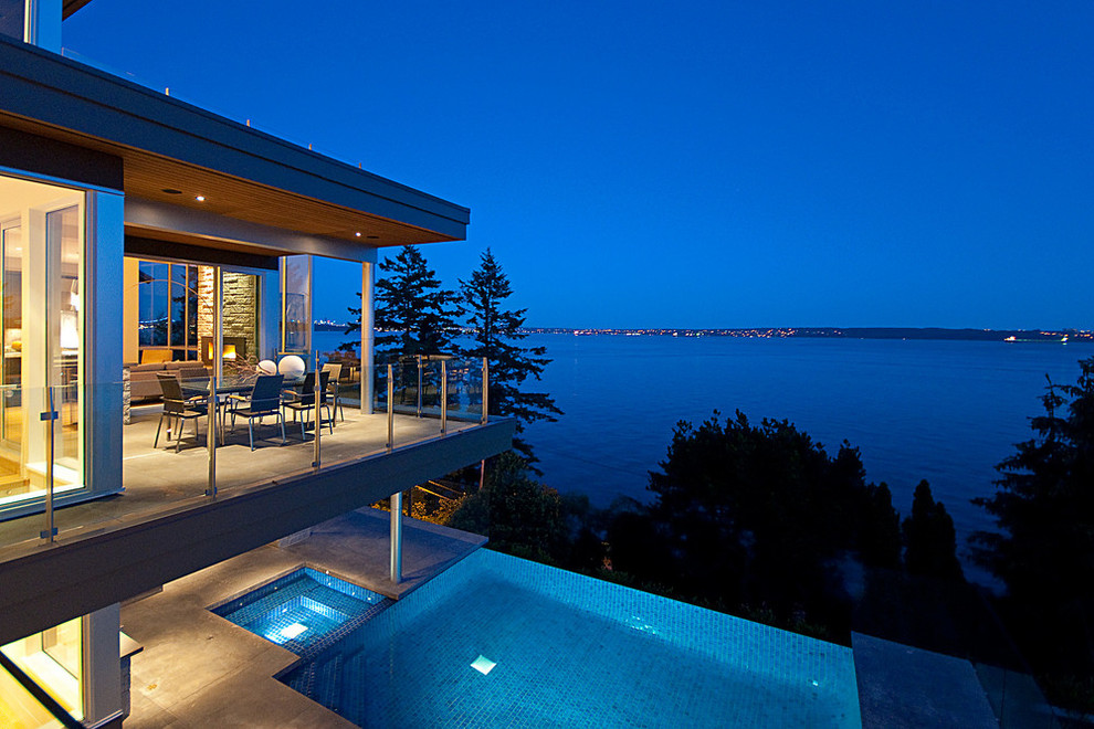 This is an example of a contemporary balcony in Vancouver with a roof extension.