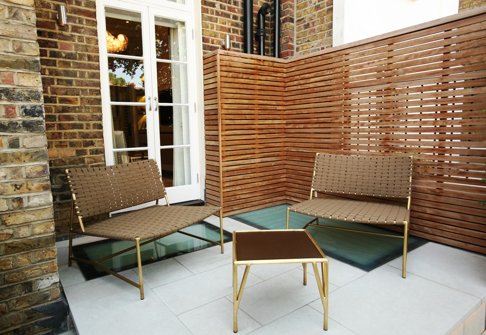 This is an example of a small contemporary balcony in London with no cover and fencing.
