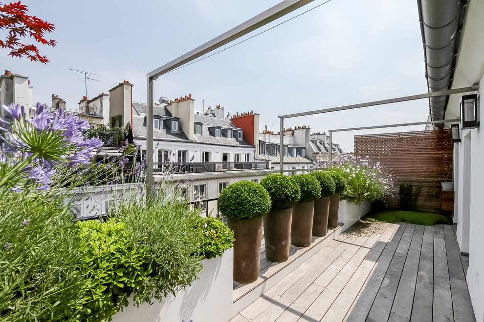 Trendy balcony container garden photo in Paris with no cover