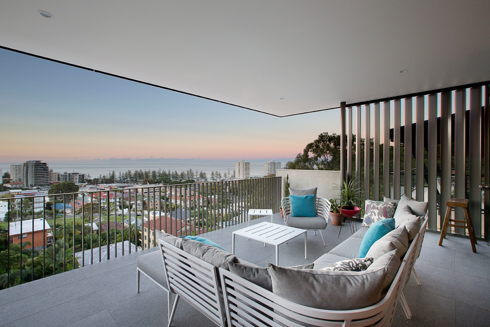 Photo of a contemporary balcony in Gold Coast - Tweed with a roof extension.