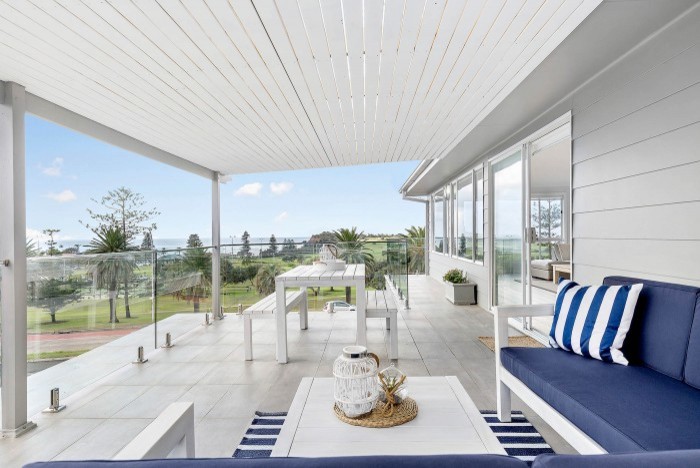 This is an example of a large coastal balcony in Sydney with a pergola.