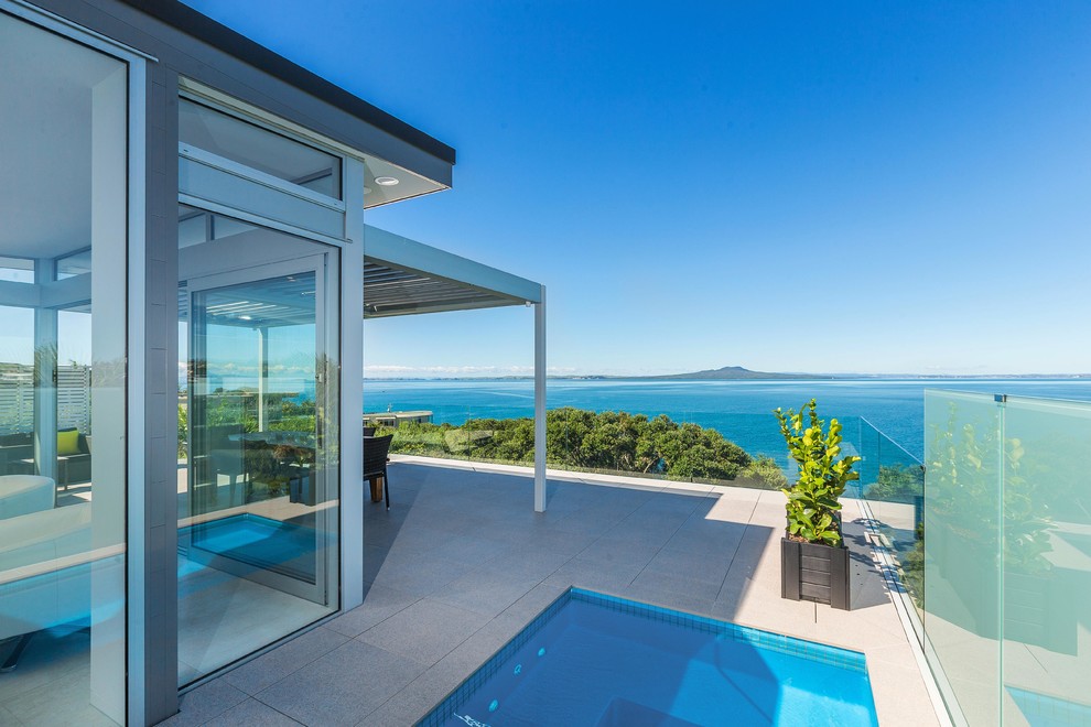 This is an example of a large contemporary balcony in Auckland with a pergola.