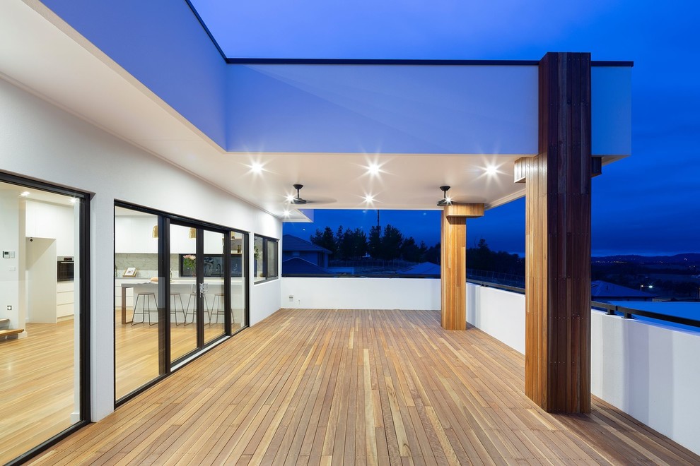 Balcony - mid-sized modern mixed material railing balcony idea in Canberra - Queanbeyan with a roof extension