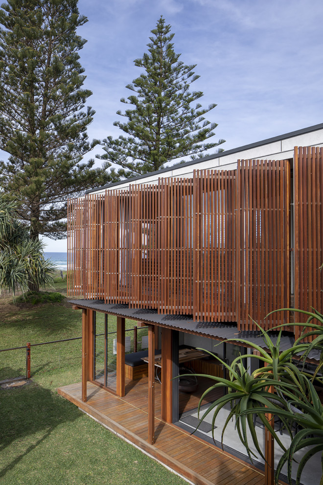 Balcony - small coastal privacy and wood railing balcony idea in Gold Coast - Tweed with an awning
