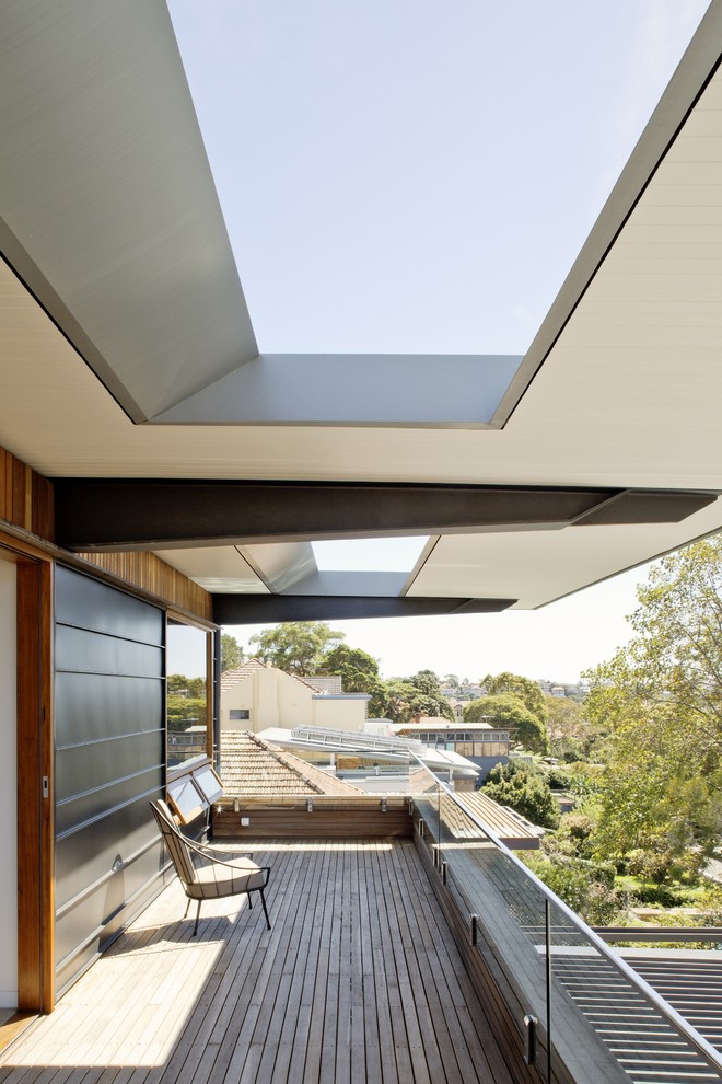 Inspiration for a contemporary balcony remodel in Sydney with a roof extension
