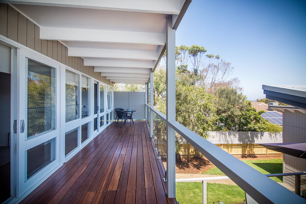 Inspiration for a medium sized nautical balcony in Melbourne with a roof extension.